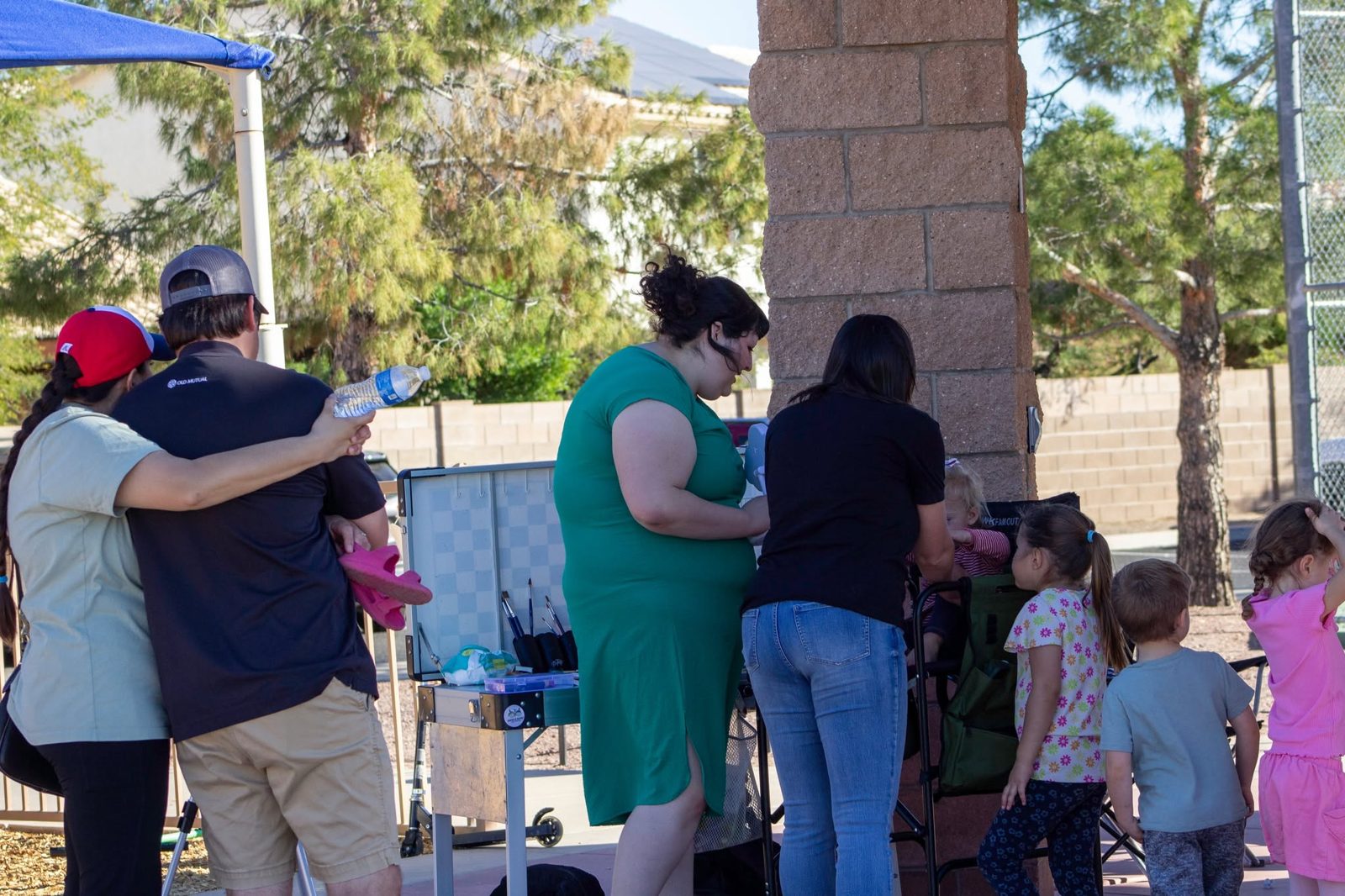Kids waiting their turn for face painting at a Tucson birthday party