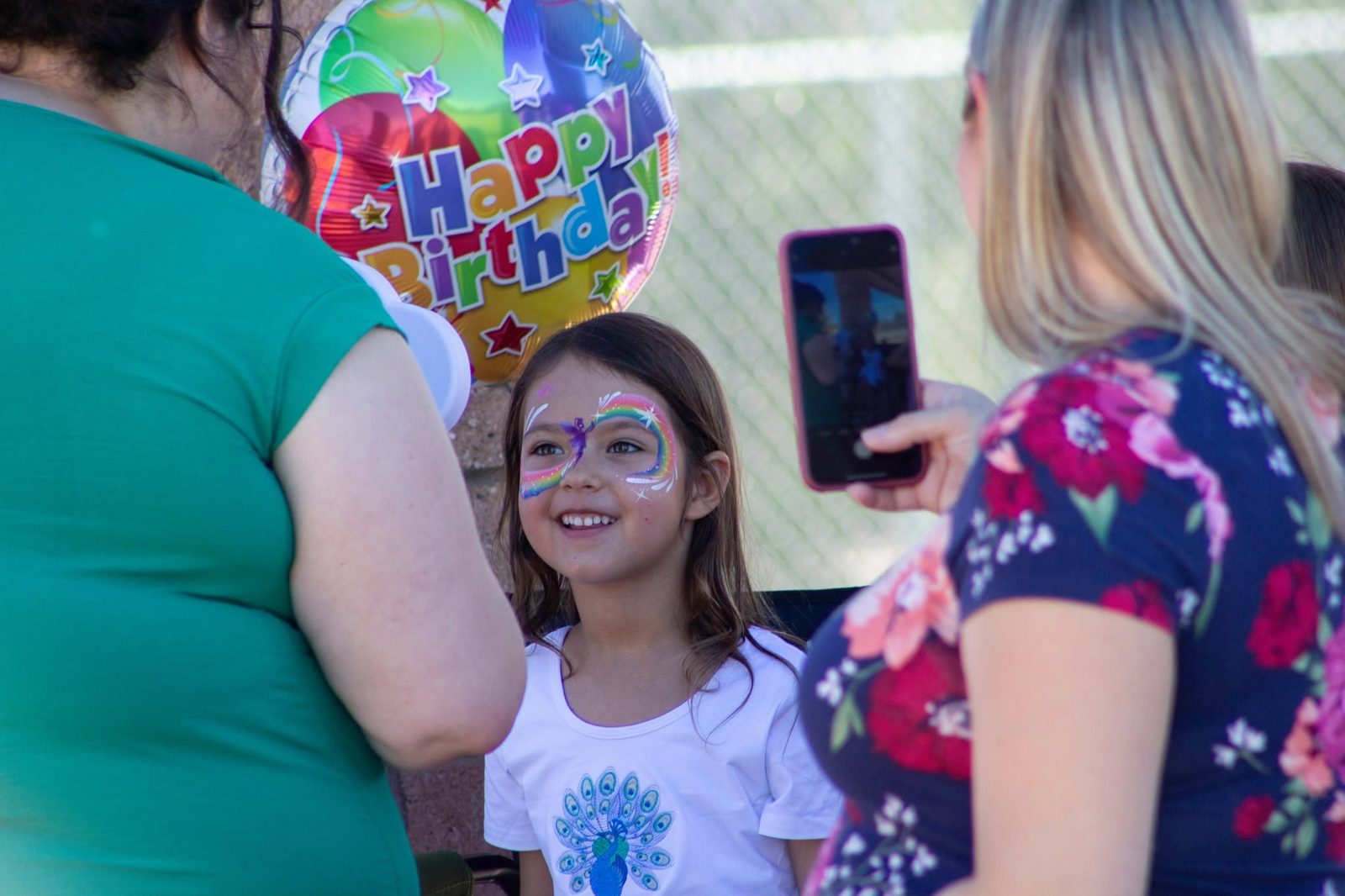 Fairy face paint design with sparkles at a birthday party