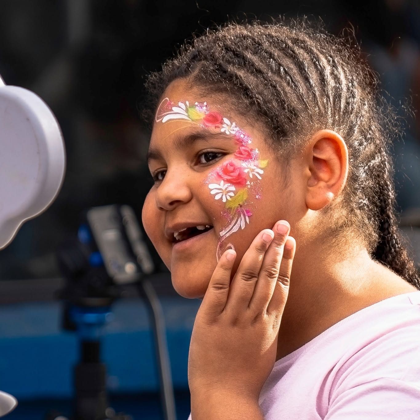 Red flower face paint design at a Tucson birthday